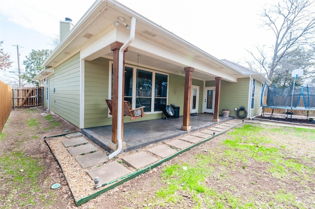 back of house featuring a patio and a trampoline