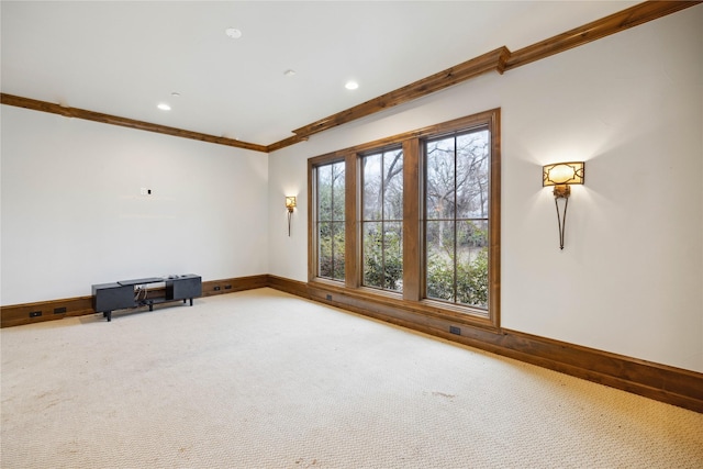 carpeted empty room featuring ornamental molding