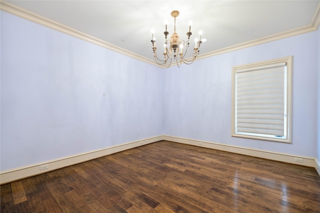 spare room featuring dark wood-type flooring, ornamental molding, and a notable chandelier