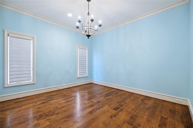 unfurnished room featuring an inviting chandelier, ornamental molding, and wood-type flooring