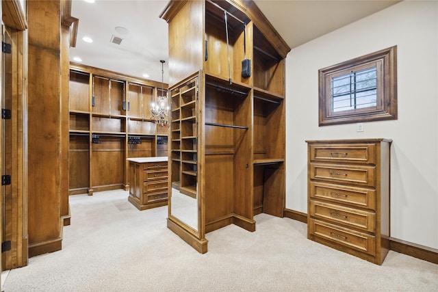 spacious closet with light carpet and a notable chandelier