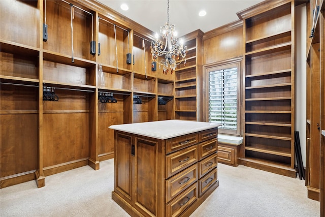 walk in closet featuring light carpet and an inviting chandelier