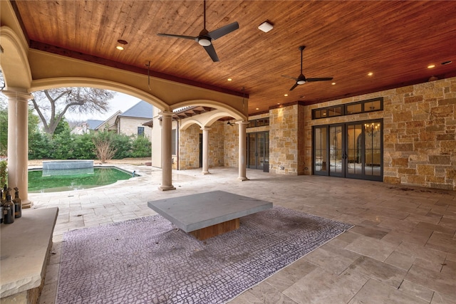 view of patio with french doors and ceiling fan