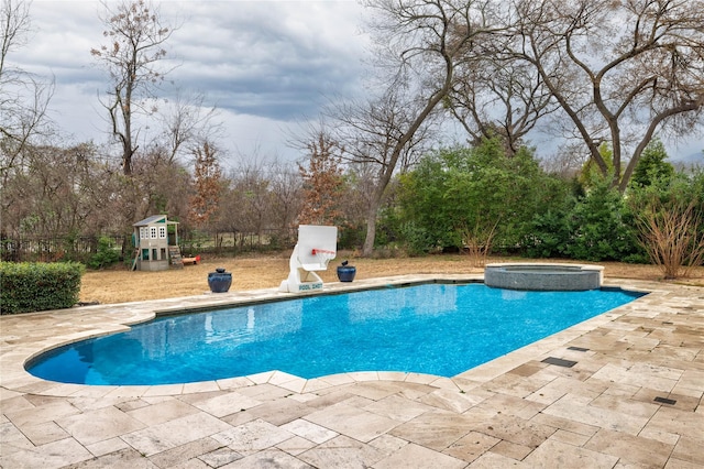 view of pool featuring a patio, a playground, and an in ground hot tub