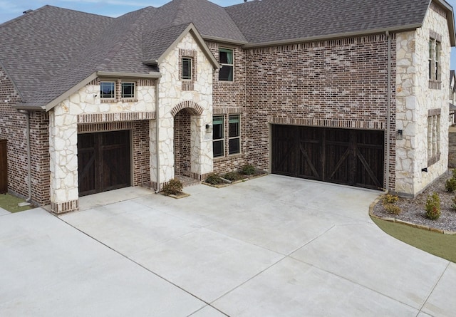 french provincial home with a garage