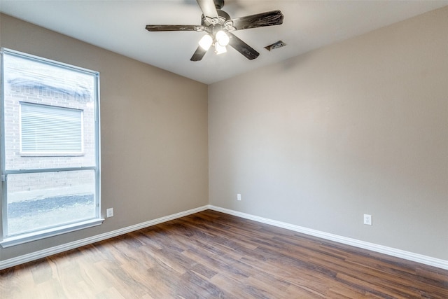 unfurnished room with ceiling fan, a healthy amount of sunlight, and wood-type flooring