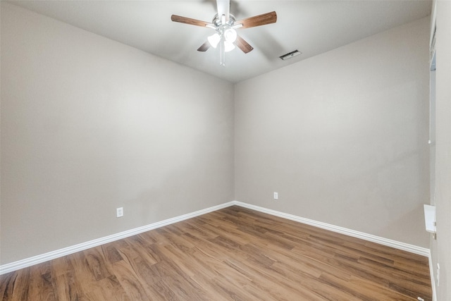 spare room with hardwood / wood-style flooring and ceiling fan