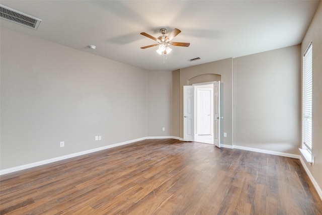 unfurnished room featuring ceiling fan and dark hardwood / wood-style flooring