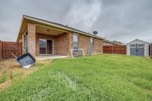 back of property featuring a patio, a yard, and a storage unit