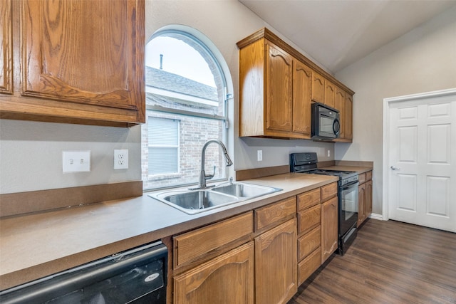 kitchen with lofted ceiling, dark hardwood / wood-style flooring, sink, and black appliances