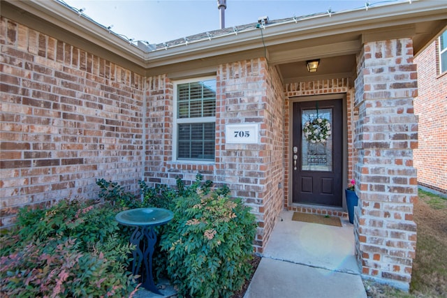 property entrance with brick siding