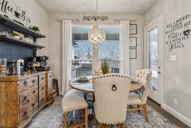 dining area featuring hardwood / wood-style flooring and a chandelier