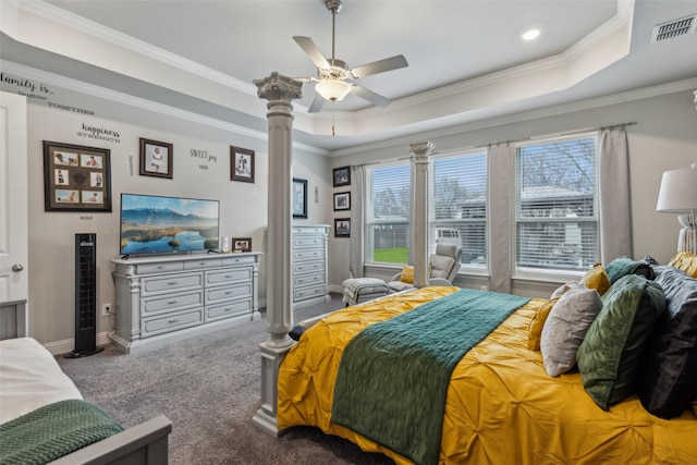 bedroom featuring ornamental molding, carpet flooring, and a tray ceiling