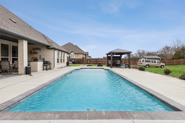 view of pool with a gazebo, area for grilling, exterior kitchen, and a patio