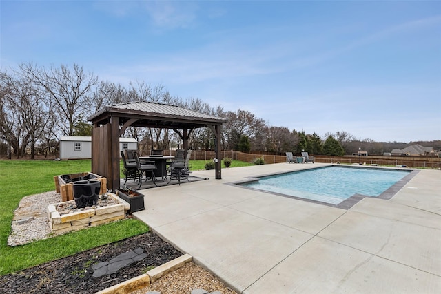 view of swimming pool featuring a storage shed, a gazebo, a lawn, and a patio