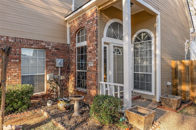 view of exterior entry with brick siding