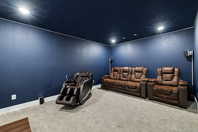 carpeted home theater featuring recessed lighting, a textured wall, and baseboards