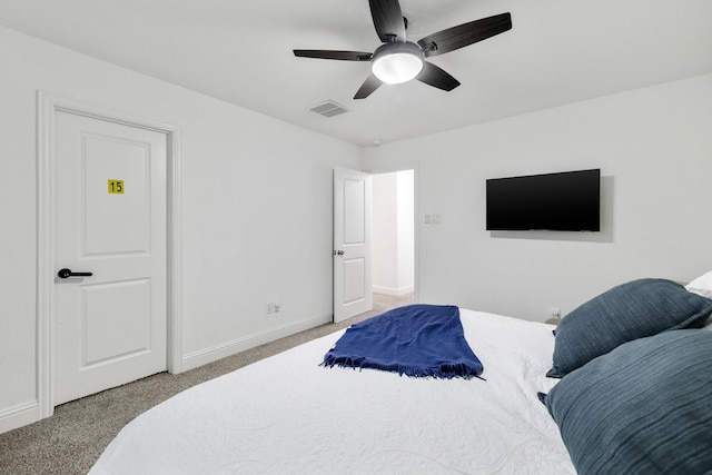 bedroom featuring a ceiling fan, visible vents, light carpet, and baseboards