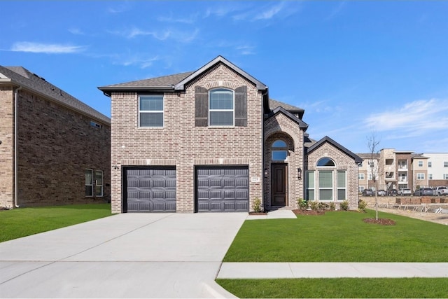 view of front facade with brick siding, a shingled roof, concrete driveway, an attached garage, and a front lawn