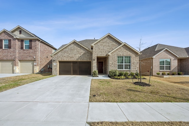 view of front of home with a garage and a front lawn