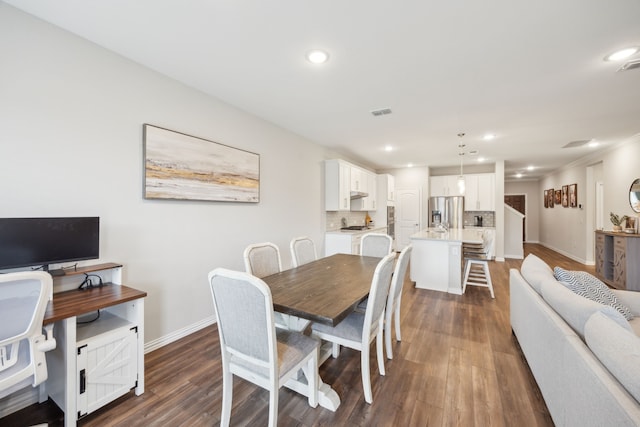 dining area with dark wood-style floors, baseboards, and recessed lighting