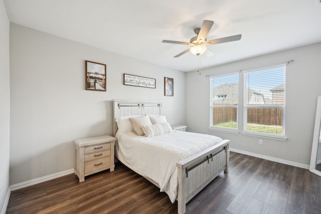 bedroom featuring dark wood-style floors, ceiling fan, and baseboards