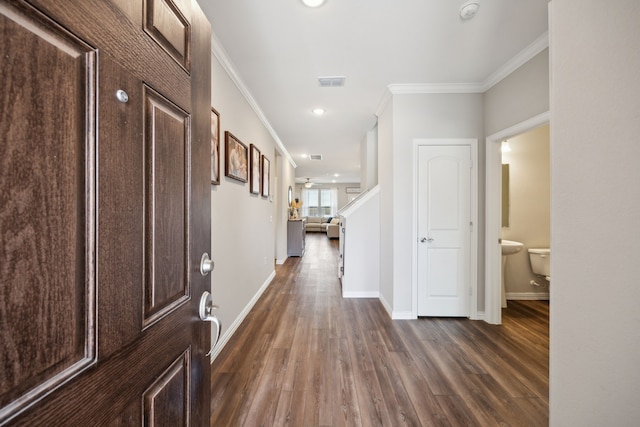 hall featuring ornamental molding and dark hardwood / wood-style flooring