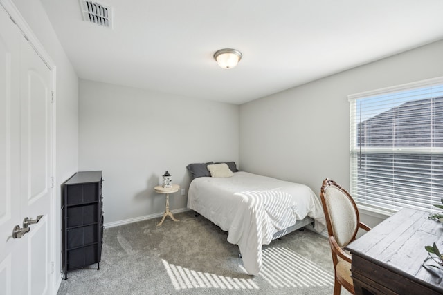 bedroom with baseboards, visible vents, and carpet flooring