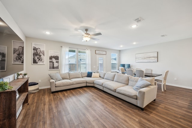 living room featuring recessed lighting, visible vents, dark wood finished floors, and baseboards