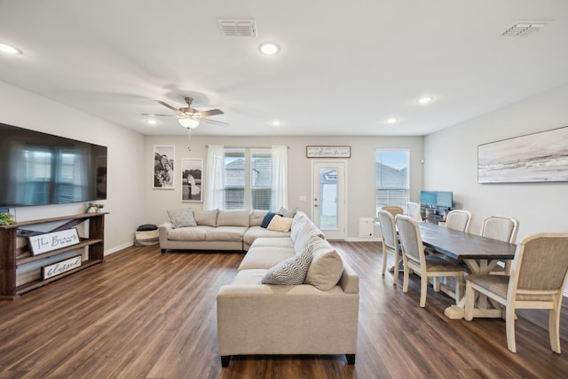 living area with dark wood-style floors, baseboards, visible vents, and recessed lighting