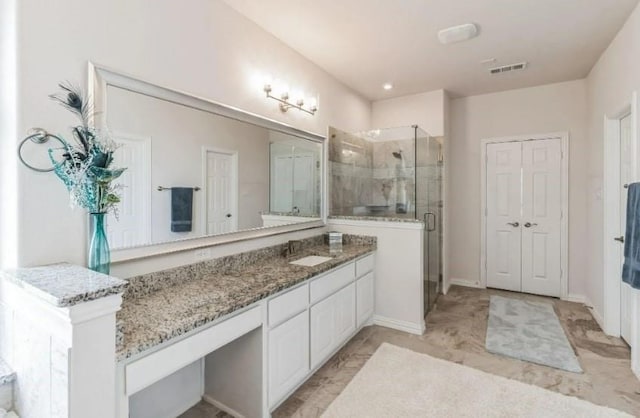 full bath with a stall shower, vanity, and visible vents