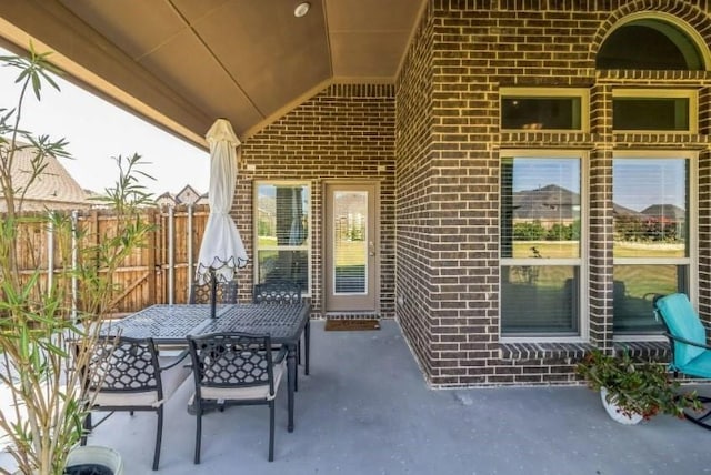 view of patio featuring fence and outdoor dining area