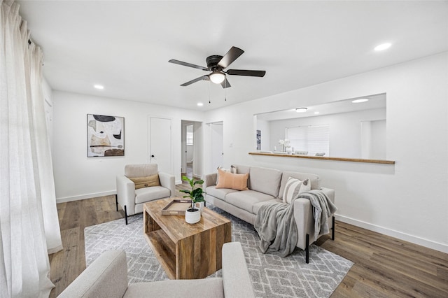 living area with recessed lighting, wood finished floors, and baseboards