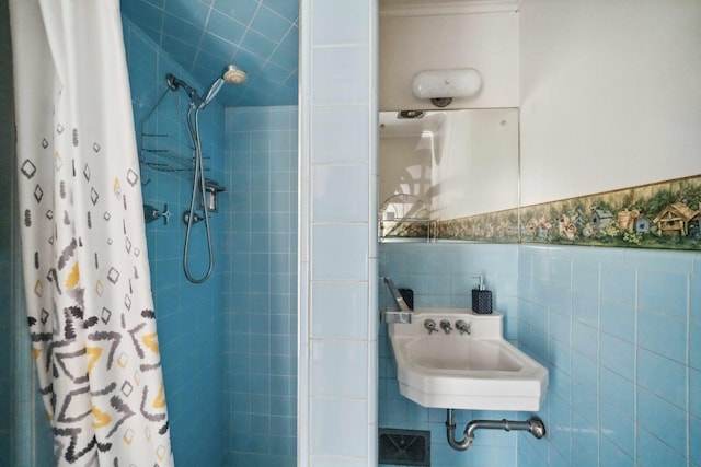 bathroom featuring tile walls, sink, and walk in shower