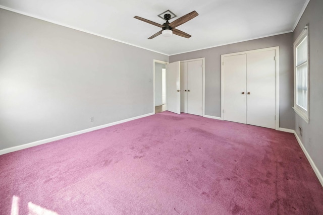 unfurnished bedroom featuring crown molding, carpet flooring, two closets, and ceiling fan