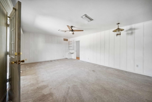 carpeted spare room with ceiling fan