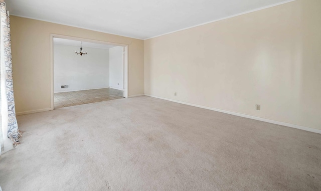 unfurnished room with a chandelier and carpet