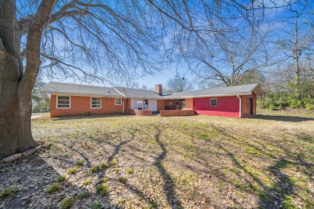 rear view of house featuring a lawn