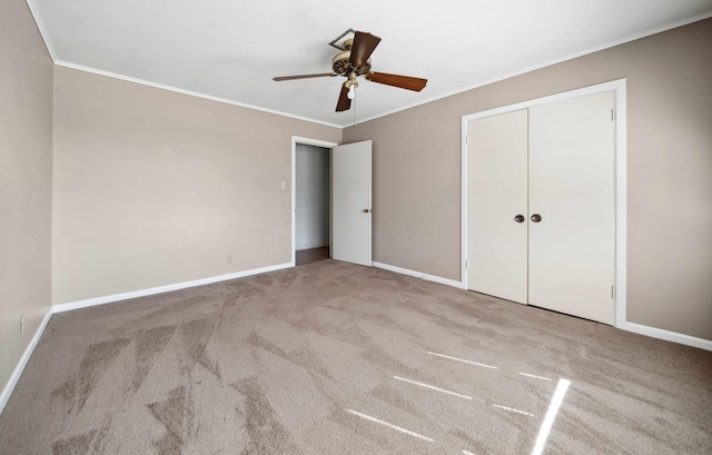 unfurnished bedroom featuring light colored carpet, ornamental molding, and a closet