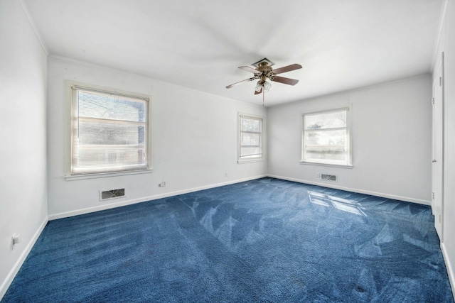 spare room featuring ceiling fan and dark colored carpet