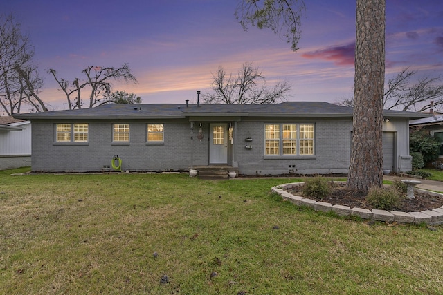 single story home with a garage and a yard