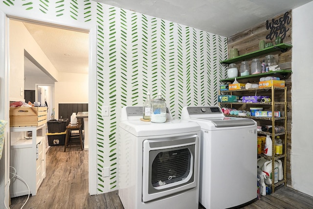 laundry area featuring dark wood-type flooring and washer and dryer