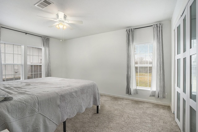 bedroom featuring light carpet and ceiling fan