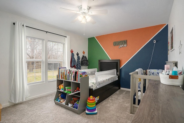 bedroom featuring carpet, a textured ceiling, and ceiling fan