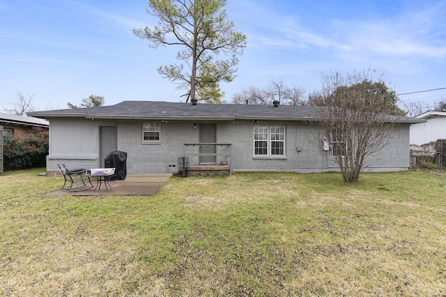 back of property with a yard and a patio