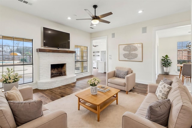 living room featuring hardwood / wood-style flooring, a wealth of natural light, and ceiling fan