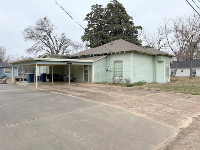 exterior space with concrete driveway and a carport