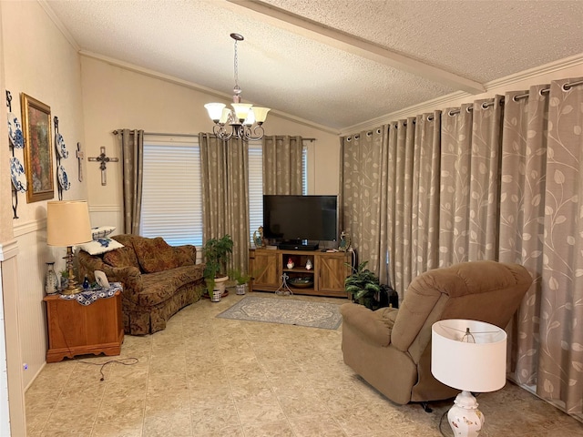 living room with ornamental molding, a chandelier, lofted ceiling, a textured ceiling, and a wainscoted wall