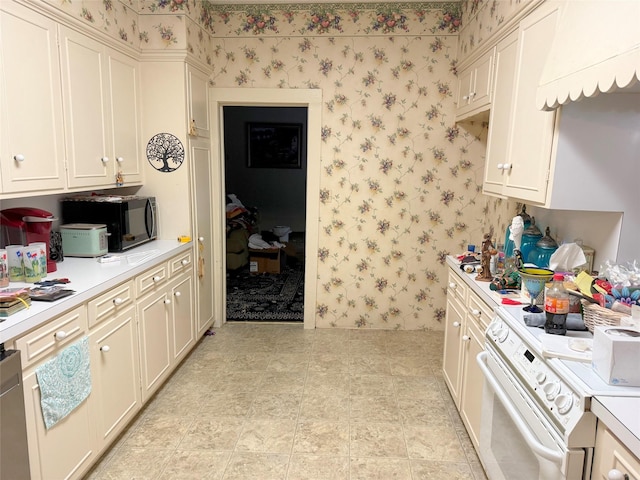 kitchen with wallpapered walls, white range, and light countertops