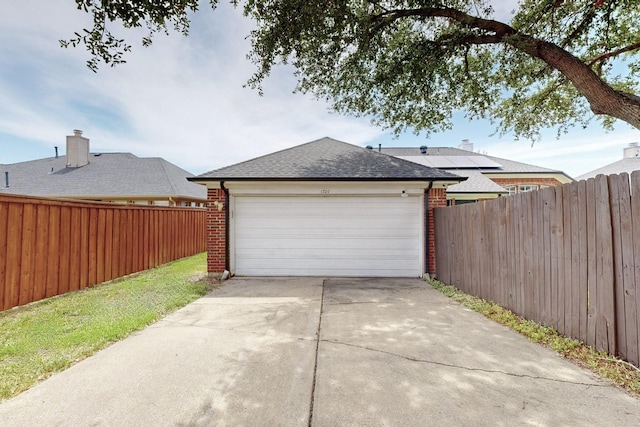 garage with driveway and fence